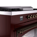 Burgundy dual fuel range side control panel with digital display and brass knobs