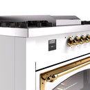 White dual fuel range control panel with brass knobs and digital display