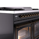 Dual fuel range control panel with bronze knobs and lit oven door with glass window