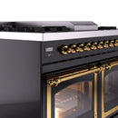Brass control knobs and glossy black control panel on a dual fuel range