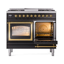 Dual fuel gas range with one oven door open and brass interior accents
