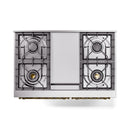 Dual fuel range cooktop with four burner grates and brass detail along the front