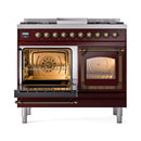 Burgundy dual fuel range with one oven lit, showing interior fan and baking rack
