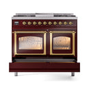 Burgundy dual-fuel gas range with two lit oven windows and brass trim, top front view