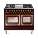 Burgundy dual-fuel gas range with two oven doors showing racks, brass trim, front view