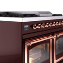 Burgundy dual fuel range control knobs with copper trim and glass oven doors