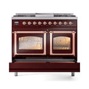Burgundy range with copper-trimmed glass oven doors and brass-toned control knobs