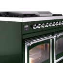 Chrome control knobs and handle on an emerald green range with an oven door open