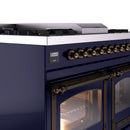 Midnight blue range control panel with bronze knobs and oven door frame with glass window