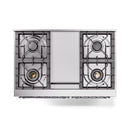Stainless steel cooktop burners with grates and central control cover on a range