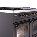 Close-up of matte graphite control panel with bronze knobs and lit oven window