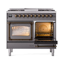 Dual oven range with one oven door open, showing lit interior and bronze interior trim