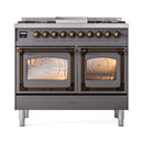 Dual glass oven doors on matte graphite range with bronze control knobs and front trim