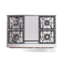 Stainless steel dual fuel range from front with four burner grates and copper trim bar.