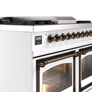 White control panel of dual-fuel gas range with bronze knobs and digital display