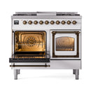 Dual-fuel gas range with both ovens open, wire racks visible, bronze trim and handles