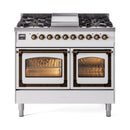 White dual-fuel range with cooktop and two ovens, both doors open, bronze trim