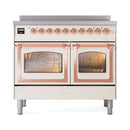 Antique white induction range with copper-trim triple glass doors and two open oven interiors.