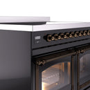 Glossy black induction range control panel with bronze knobs and open oven door