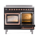 Glossy black induction range with one oven open showing interior racks and copper trim