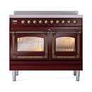 Burgundy induction range with two large glass oven doors open and bronze control knobs