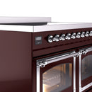Burgundy range door handle with chrome trim and control knob row above.