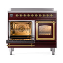 Burgundy induction range with left oven open and right glass door, brass interior