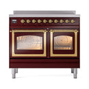 Burgundy induction range with triple glass doors and brass trim, front view