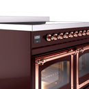 Burgundy range side view with copper control knobs and oven door handle rails