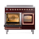 Burgundy induction range with both ovens open, illuminated interiors and copper trim