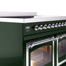 Chrome control knobs on emerald green range beside oven door with racks inside