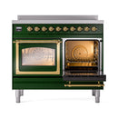 Emerald green range with brass-trimmed dual ovens and an open door showing racks inside