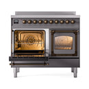 Matte graphite induction range with both ovens open, bronze-lit interiors and racks