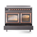 Matte graphite induction range with twin oven doors open, copper trim and heating elements