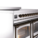 Bronze-trim control panel with knobs and two glass oven doors