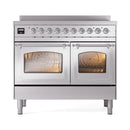 Stainless steel induction range with two oven doors closed and warm-lit windows