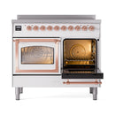 White dual-oven with one door open, copper handle bars, and warm interior light