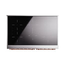 Induction cooktop panel with black glass and copper control ring along the bottom edge