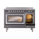 Matte graphite induction range with chrome-trim double doors; right oven door open, interior lit.
