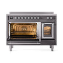 Matte graphite induction range with chrome-trim doors; left oven door open, right door closed.
