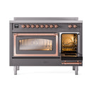Induction range with one oven door open, showing illuminated interior racks and copper frame