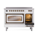 White 48-inch induction range with bronze trim; lit ovens behind triple-glass doors