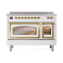 White induction range with brass-framed glass oven doors and two oven windows